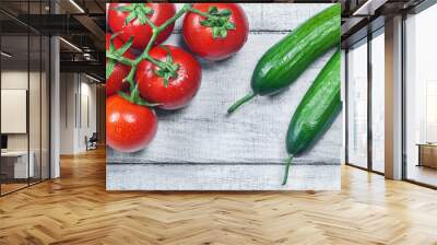 ripe fresh grape tomatoes and cucumbers on white wooden background. Cherry tomato and cucumber vegetable salad concept Wall mural