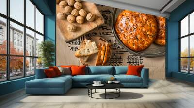 Turkish pastry, scone or bun with walnut on traditional Tokat table cloth, homemade pastry concept Wall mural