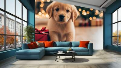 A cute golden puppy sits beside a gift, with a festive background. Wall mural