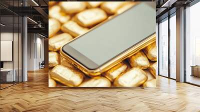 A smartphone resting on a pile of gold bars, symbolizing wealth and technology. Wall mural