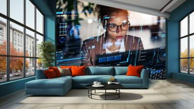 Black woman working in office and futuristic graphical user interface concept. ICT (Information Communication Technology). System engineering. Wall mural