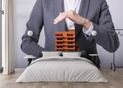 business person holds apartment building miniature model Wall mural