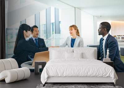 Group of multinational business people shaking hands in a lobby Wall mural