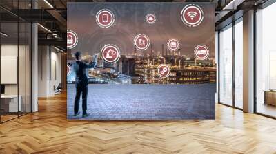 modern industry buildings and various technological symbol icons, young businessman holding a tablet PC, smart factory, internet of things, smart city, abstract image visual Wall mural