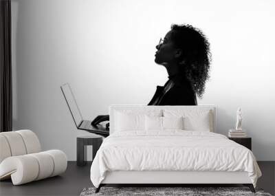 Profile silhouette of black woman using laptop PC in studio shot. Wall mural