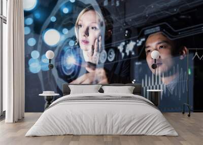 Two persons looking at graphical user interface. Futuristic business concept. Wall mural