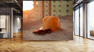 Yellow hard safety wear helmet hat in the project  at construction site Wall mural