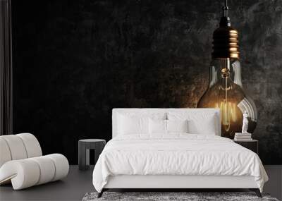 Classic Edison light bulb against black backdrop with text space Wall mural