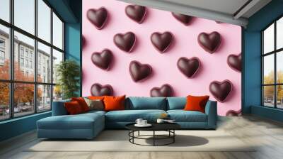 Valentine s Day backdrop featuring heart shaped chocolates set against a pink surface Wall mural