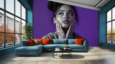 Photo of adorable lovely girl wear stylish clothes two arms touch face looking empty space poster isolated purple color background Wall mural