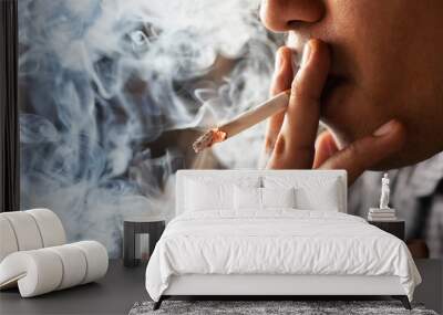 asian man smoking a cigarette smoke spread dark background. concept campaign No smoking and health care. Wall mural