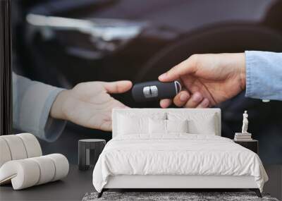 businessman exchange handing over the car keys for to a young women. Wall mural