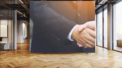 Closeup of a businessman hand shake businesswoman between two colleagues  OK, succeed in business Holding hands. Wall mural