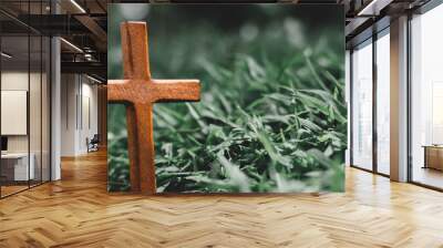 cross on a small grave surrounded by grass hill. marker standing alone. Crucifixion Of Jesus Christ. Religion concept. Wall mural