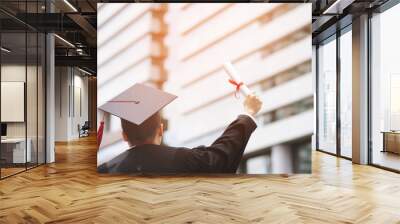 graduate are celebrating graduation. Happiness feeling hand hold show hat and diploma certificate in background School building.  Congratulation education during Commencement day University Degree.  Wall mural