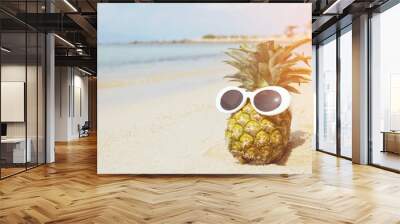 pineapples wearing stylish mirrored sunglasses on the sand against turquoise sea. Tropical idea summer vacation on the beach concept. Sunny day on the beach travel of tropical island. filter vintage Wall mural