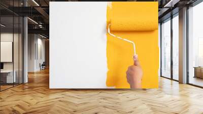 Roller Brush Painting, Worker painting on surface wall  Painting apartment, renovating with yellow color  paint. Leave empty copy space white to write descriptive text beside. Wall mural