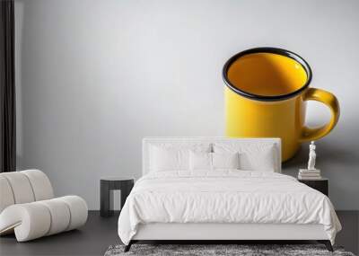 yellow mug with black rim on white surface, high angle view Wall mural