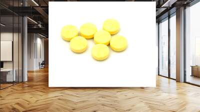 yellow pills on white background Wall mural