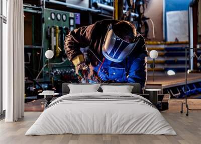 Industrial worker welding at the factory Wall mural