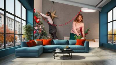 Mother and daughter decorating home for christmas holidays Wall mural