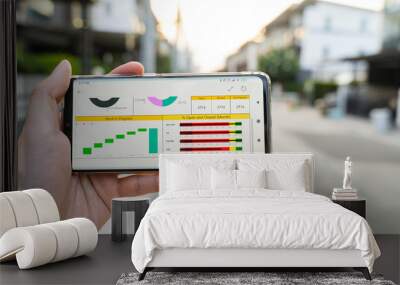 Business man analysis graph visualization on mobile for anywhere anytime Wall mural