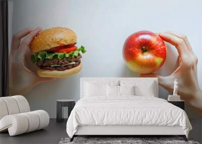 unhealthy vs healthy food. Burger and apple in different hands isolated on white background Wall mural