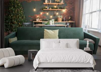 Christmas studio interior in white colors during daytime with a chester style sofa, Christmas tree with presents, chest of drawers and two widows at the background Wall mural