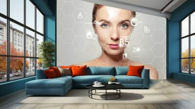 woman face portrait with graphic icons of vitamins and minerals for skin treatment Wall mural