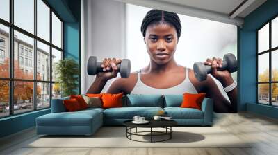 Face portrait, dumbbells and black woman training in gym for muscle, strength and power. Sports, energy and young female bodybuilder weight lifting in fitness center for wellness, workout or exercise Wall mural