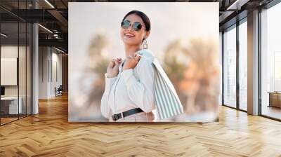 Fashion, style and shopping bags with a woman luxury sunglasses on an urban city street enjoying travel. Stylish, tourism and rich arab female customer or tourist happy about sale discount purchase Wall mural