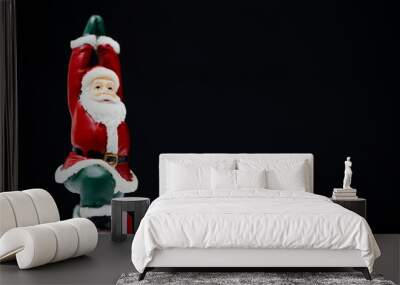 Santa Claus ready for give gift for Christmas eve and poses like a yoga practice be easily changed into overlay isolated on black background with copy space Wall mural