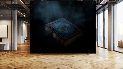 Magic old book on a dark background, smoke, fog, neon light in the dark.  Wall mural