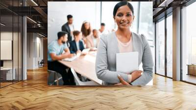 This is where we come up with all our winning ideas. Cropped portrait of an attractive young businesswoman attending a meeting in the boardroom with her colleagues in the background. Wall mural