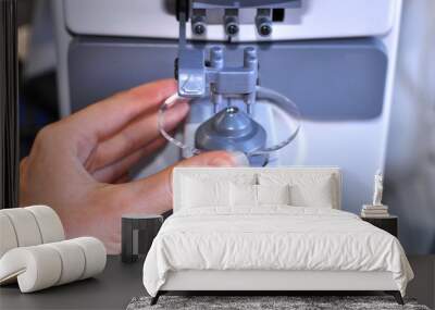 Female optician measuring and preparing glasses,raw material on the digital device in optical store  Wall mural