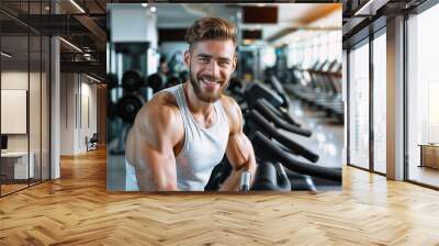 A handsome man working out in the gym Wall mural