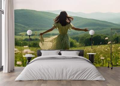 A young woman runs carefree over a beautiful flower meadow in sunshine. Wall mural