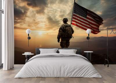 american soldier holding a flag on the peak of a mountain at sunset. copy space for text Wall mural