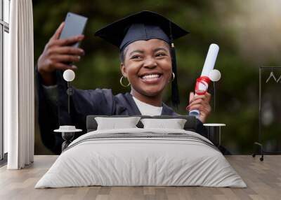 Everyone will be so proud of me. Shot of a young woman taking selfies on graduation day. Wall mural