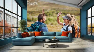 High five, success and couple hiking in nature with motivation, goal and support in Puerto Rico. Teamwork, celebration and man and woman excited about travel adventure on a mountain for holiday Wall mural