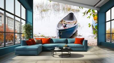 a blue solo white water canoe sits on the bank of the madawaska river, an iconic paddling destinatio Wall mural