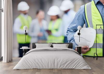 Businessman, architect and helmet for safety in construction, project management or meeting on site. Man holding hard hat for industrial architecture, teamwork or maintenance and building in the city Wall mural