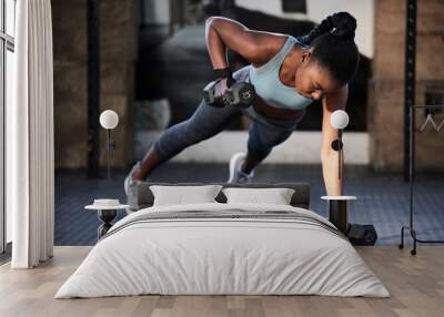 Gym workout, dumbbells and a black woman on the floor for fitness, exercise and training for sports. Strong, healthy and an African athlete with weights for strength, muscle and health at a club Wall mural