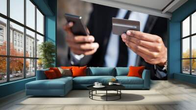 Hands, phone and a credit card for an online payment, shopping or ecommerce. Contact, finance and closeup of a businessman on a mobile app for banking, investing money and paying on the internet Wall mural