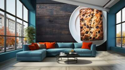 Delicious cherry cake on a white plate contrasts with a rustic wooden table, promising a sweet treat with fresh cherries on top Wall mural