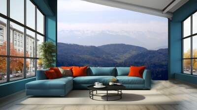 Aerial view over rural landscape with Swiss Alps in the background seen from local mountain Uetliberg on a blue cloudy spring day. Photo taken April 21st, 2022, Zurich, Switzerland. Wall mural