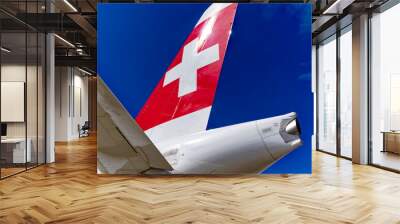 Close-up of Swiss flag at tail of passenger airplane at 75 year anniversary of Swiss Zürich Kloten Airport on a sunny summer day. Photo taken September 1st, 2023, Kloten, Canton Zürich, Switzerland. Wall mural