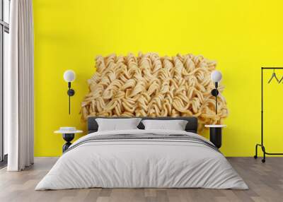 Dry instant noodles vermicelli on yellow background Wall mural