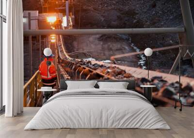 Nyngan Australia June 20th 2012 : Shallow depth of field image of a miner inspecting ore rocks on a conveyor in NSW Australia Wall mural