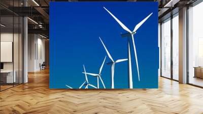 A group of wind turbines with blue sky background Wall mural